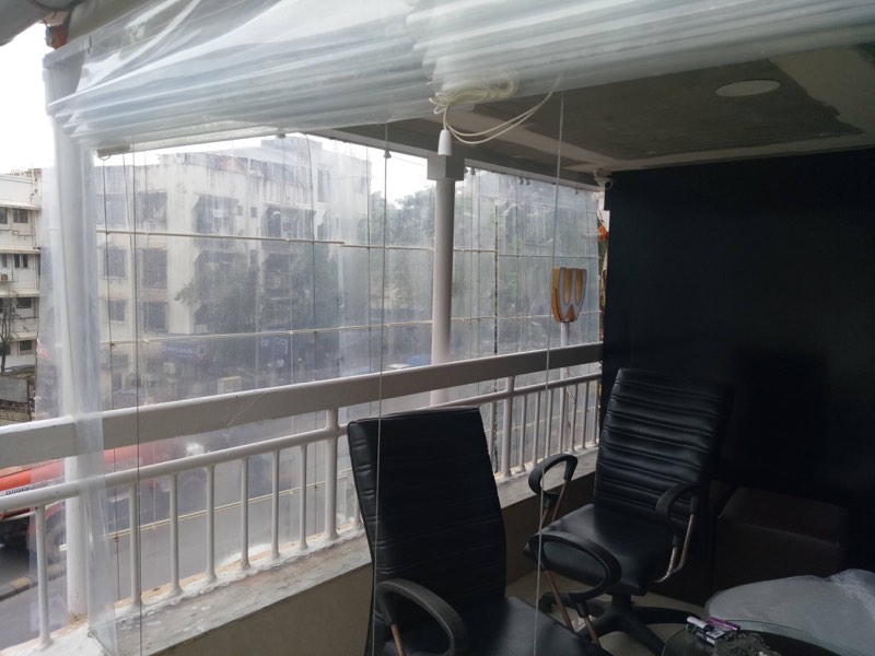 Transparent PVC monsoon blinds on an office balcony