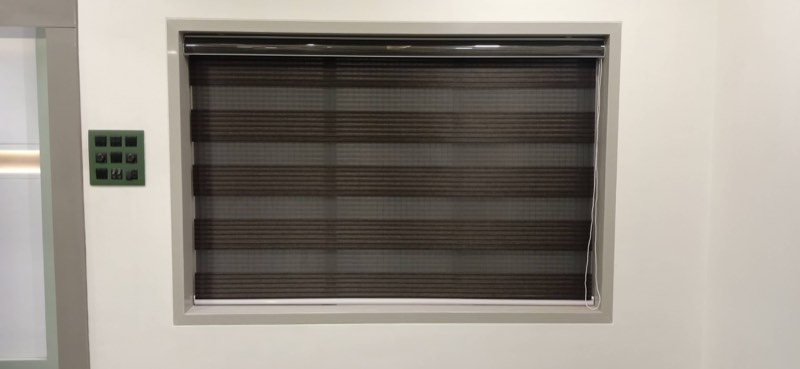 Grey zebra blind on a small window