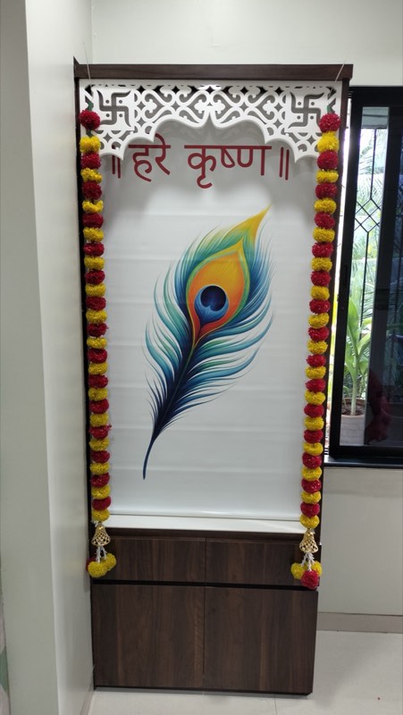 Custom-printed peacock-feather blind in a marigold-framed mandir
