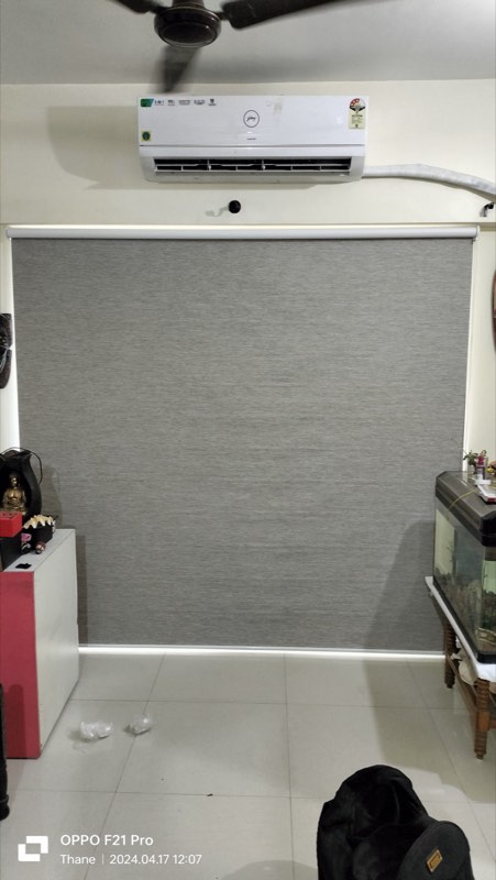 Tall grey roller blind next to an aquarium