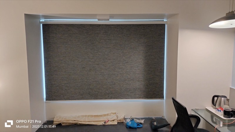 Grey roller blind over a home-office desk