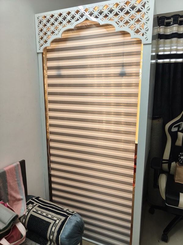 Zebra blind fitted inside a carved jaali arch